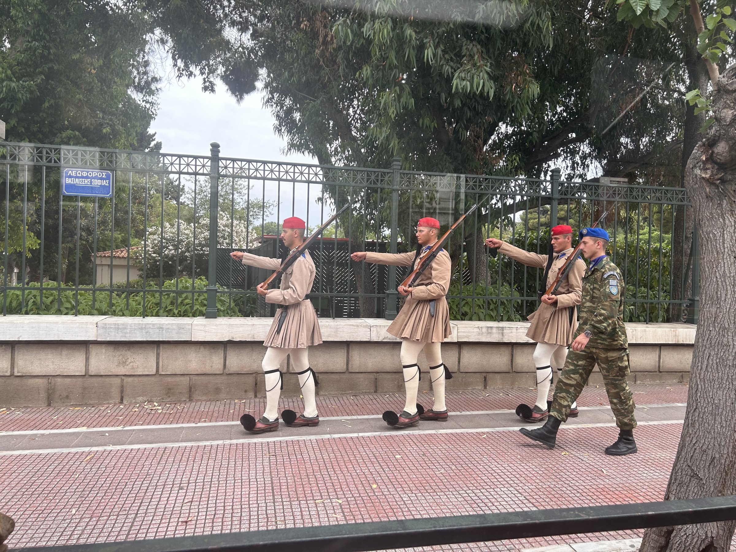 Evzones ceremonial guards marching along an Athens street