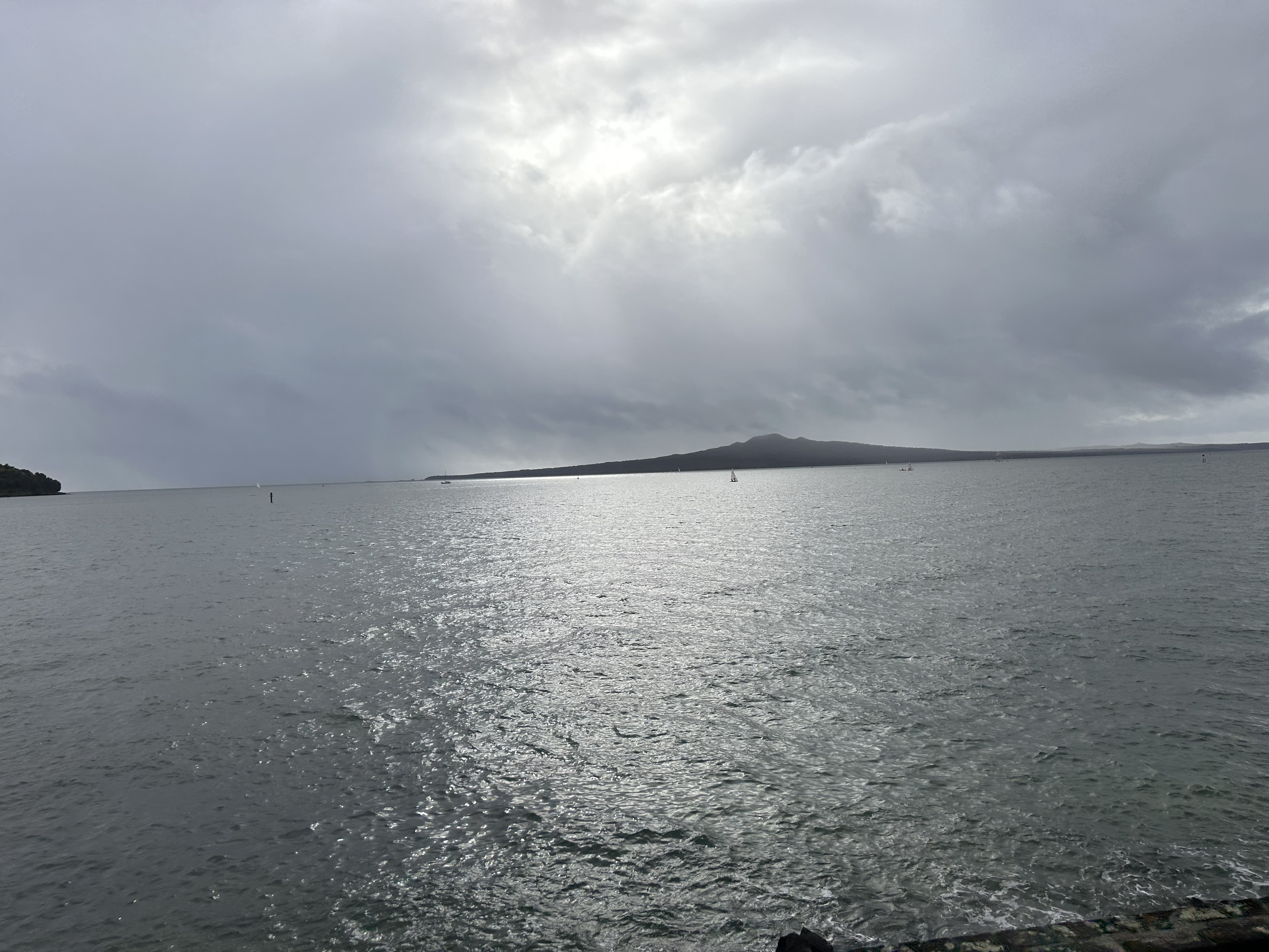 Rangitoto Island beneath dramatic clouds across Auckland Harbour