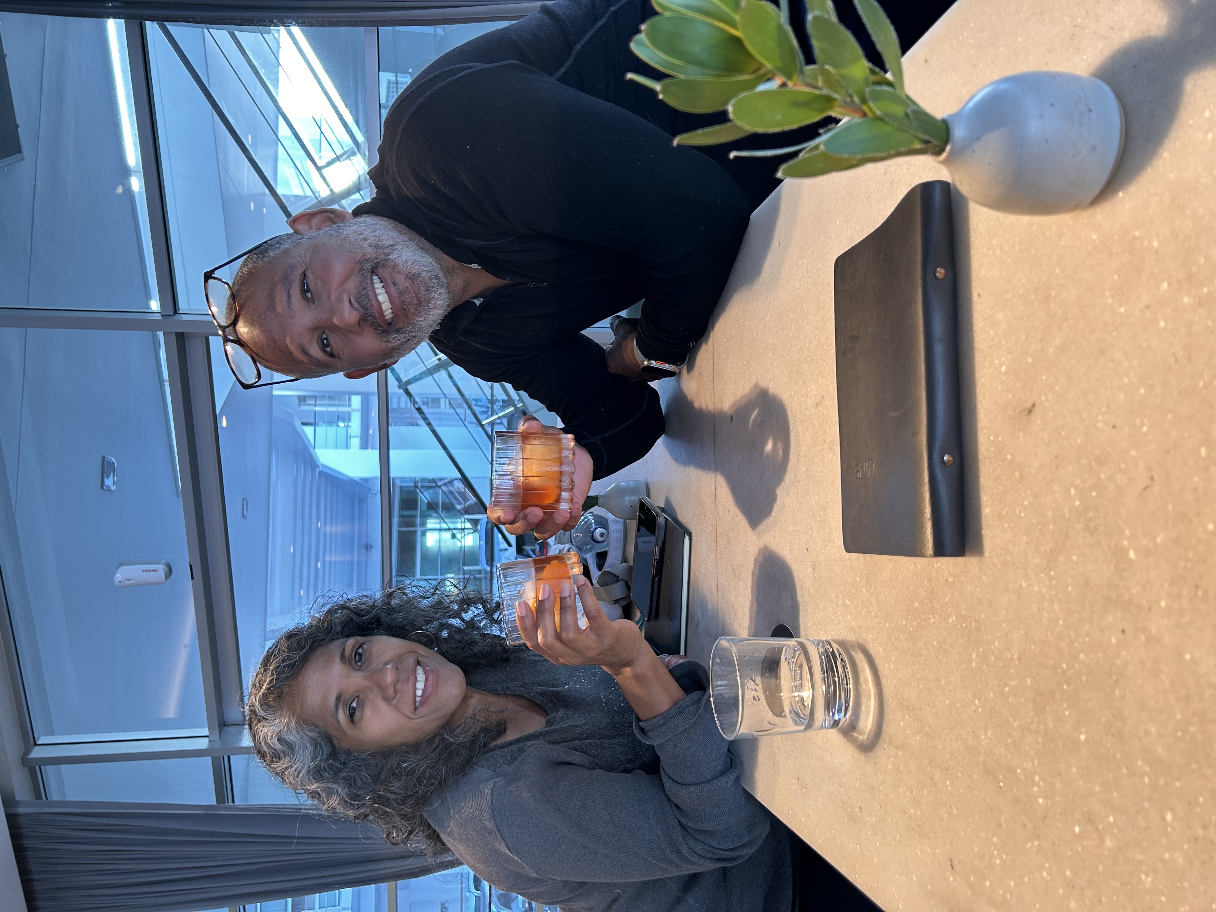 Hiram and Marlene raising glasses together in Auckland