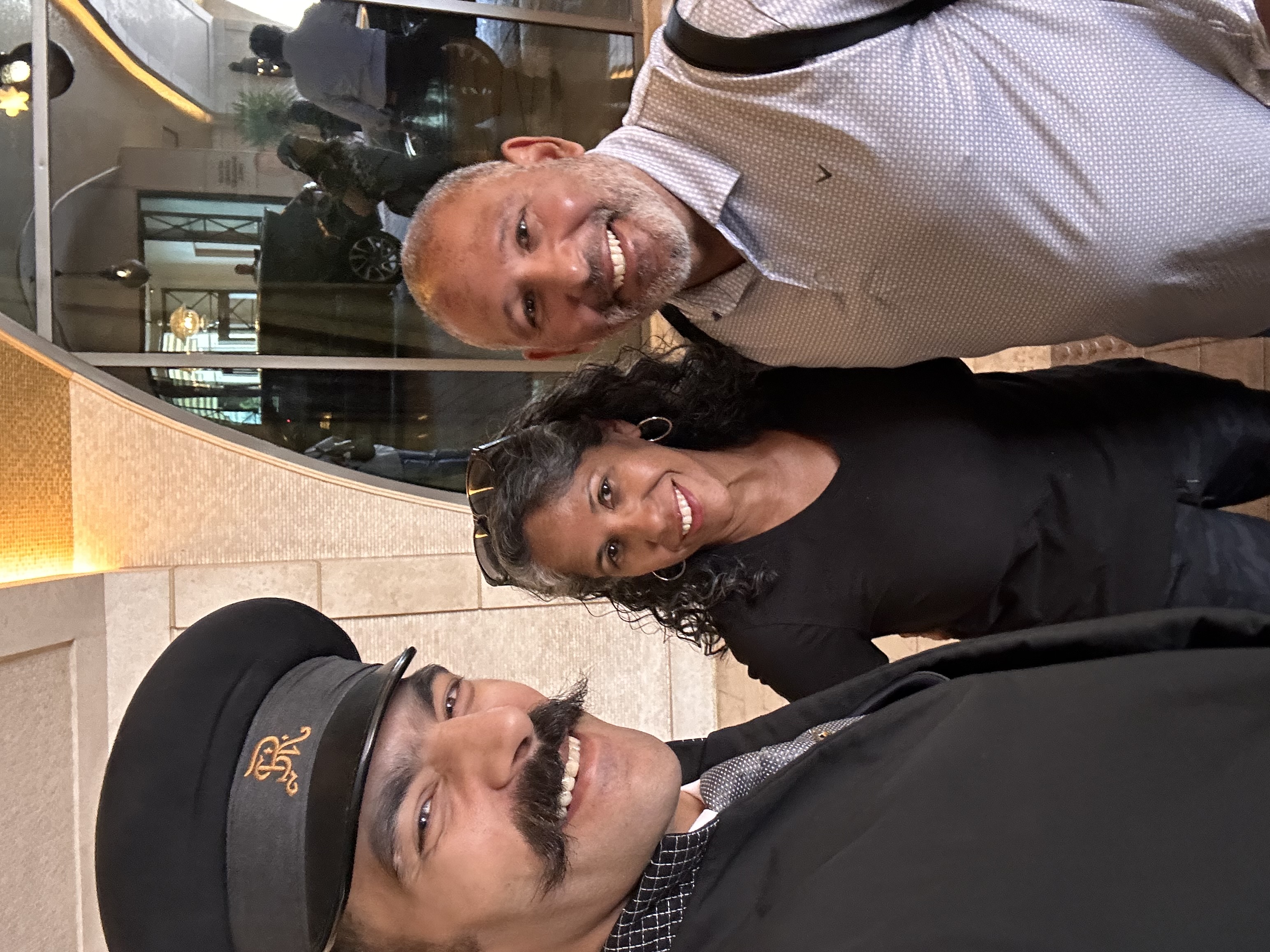 Hiram and Marlene smiling with their St. Regis Cairo butler