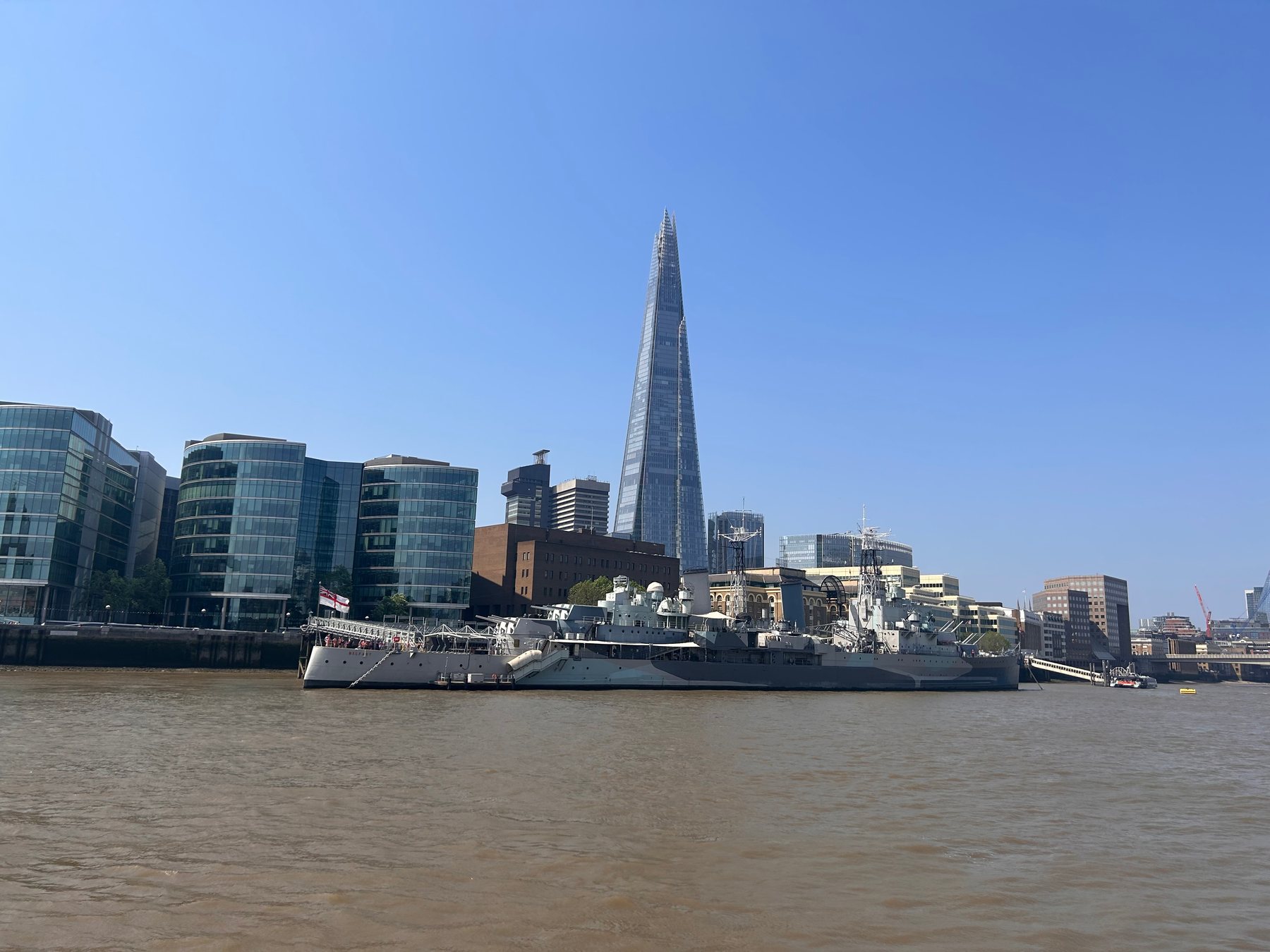 HMS Belfast on the River Thames with The Shard rising behind it