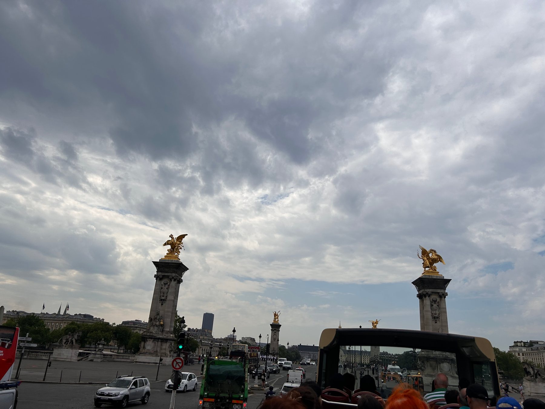 Pont Alexandre III in Paris beneath a sweeping cloudy sky
