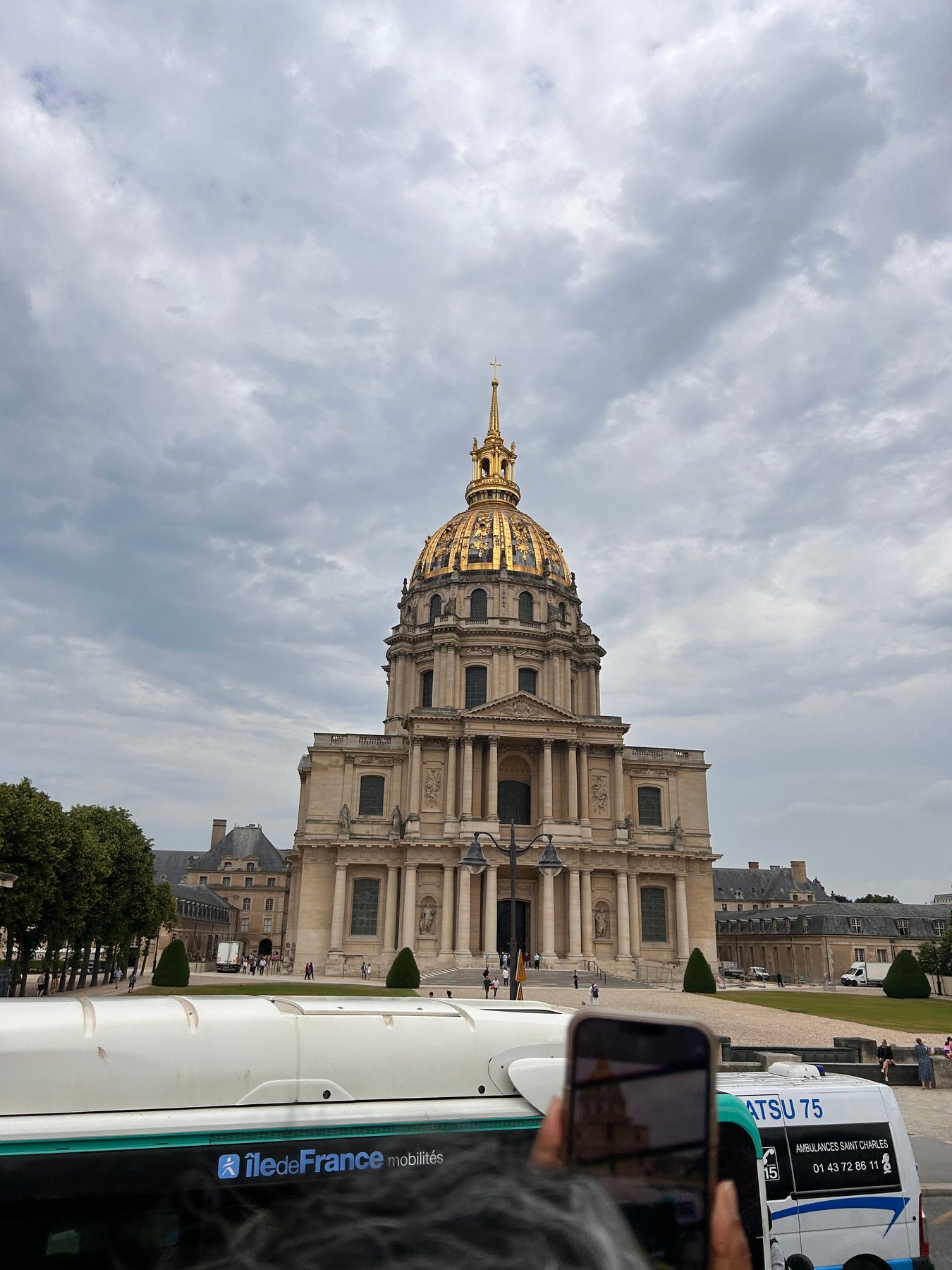 The golden dome of Les Invalides in Paris beneath cloudy skies