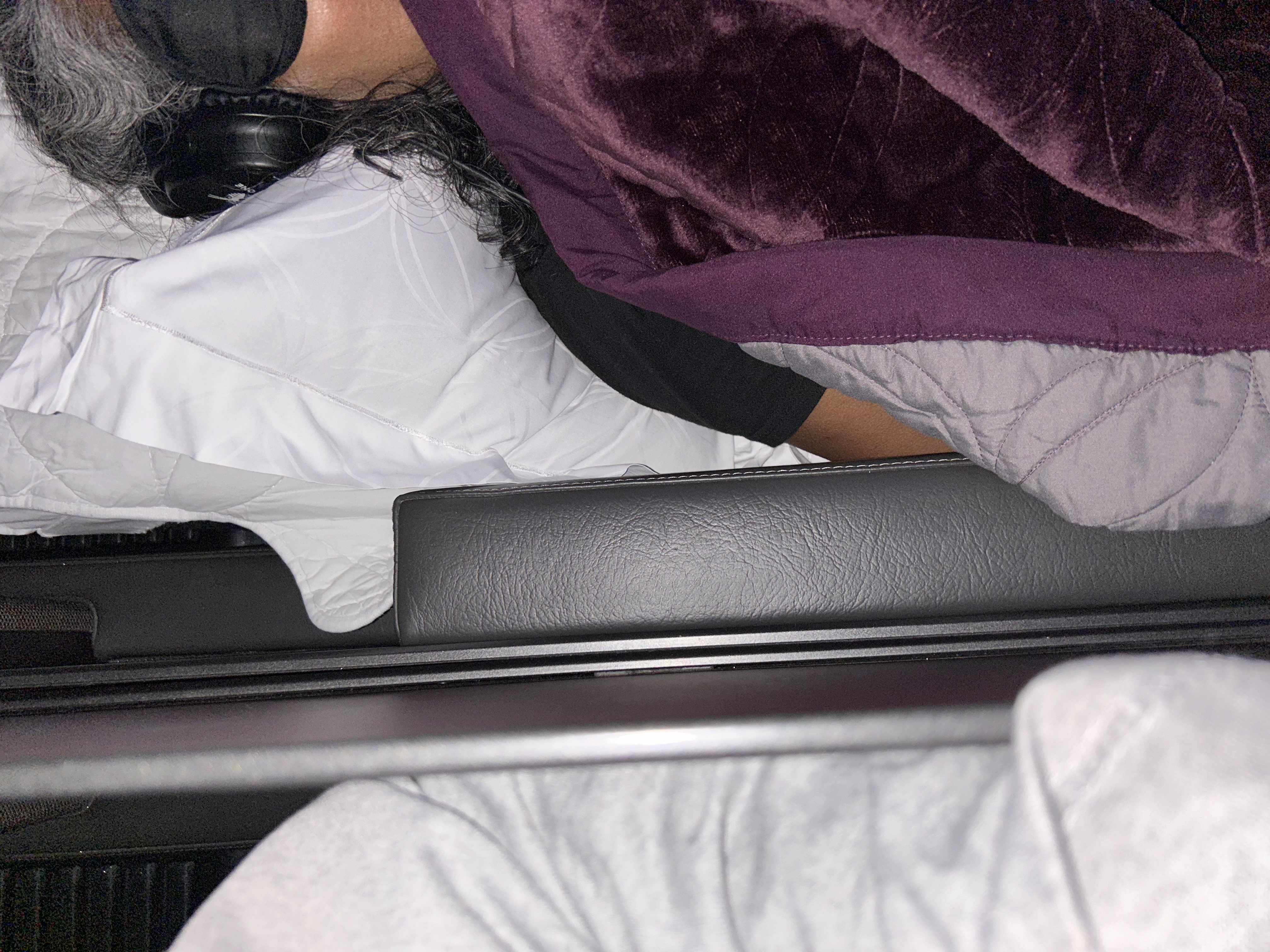 Marlene sleeping beneath a blanket during the journey to Vietnam